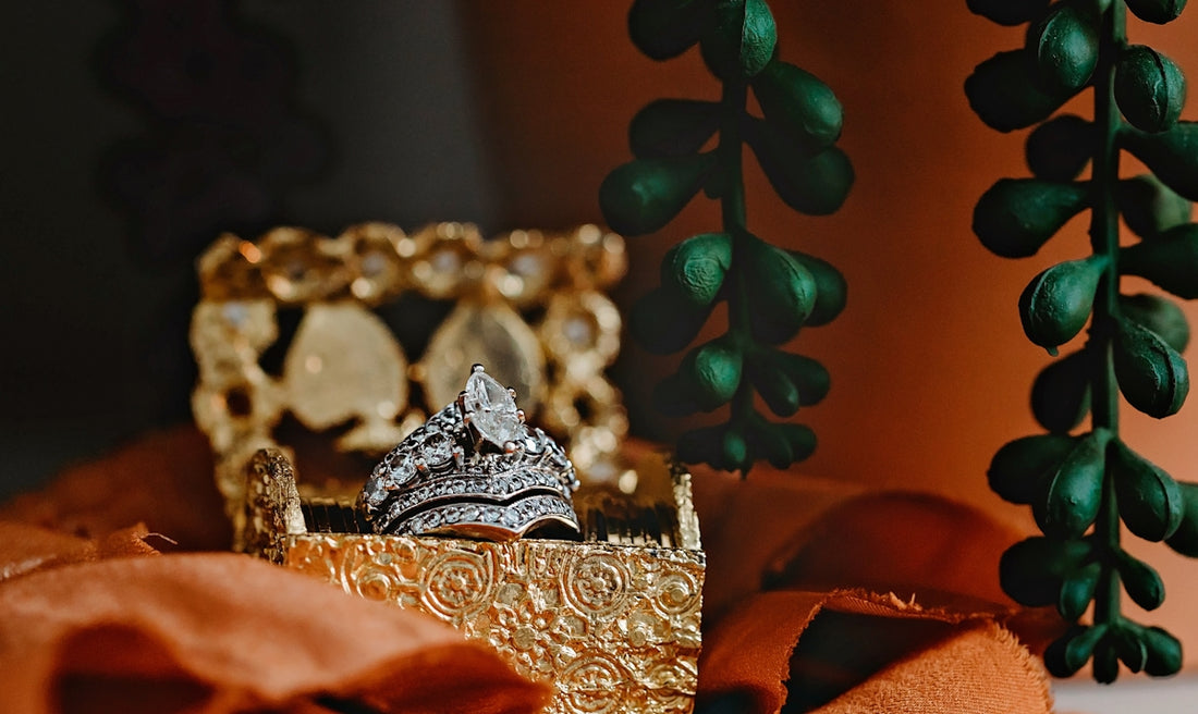 silver and gold crown on red textile