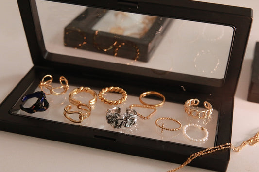 a display case with a variety of rings in it