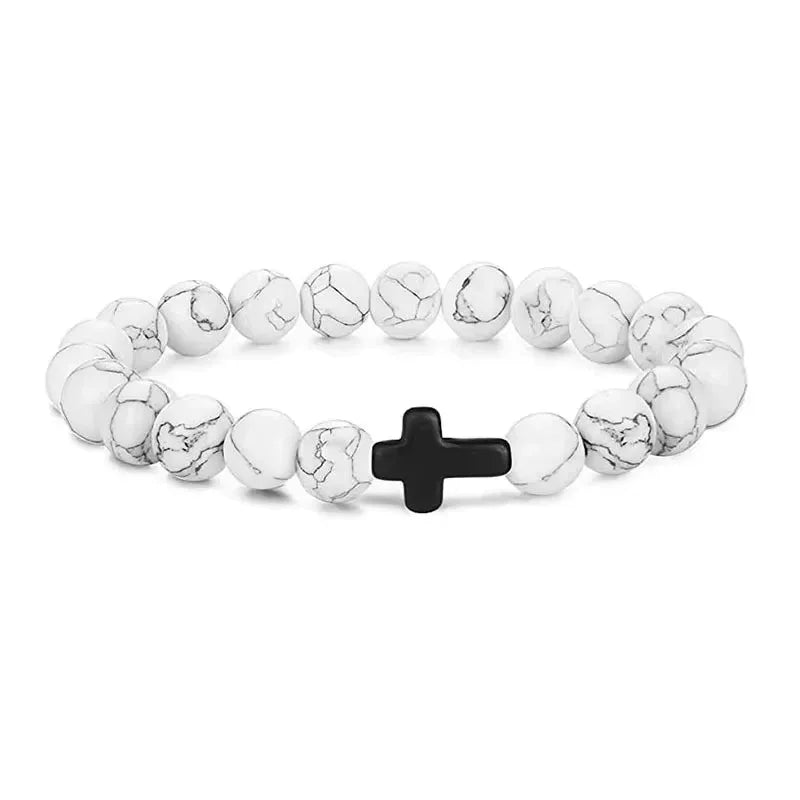 White howlite beaded bracelet with black cross charm, minimalist unisex jewelry style.