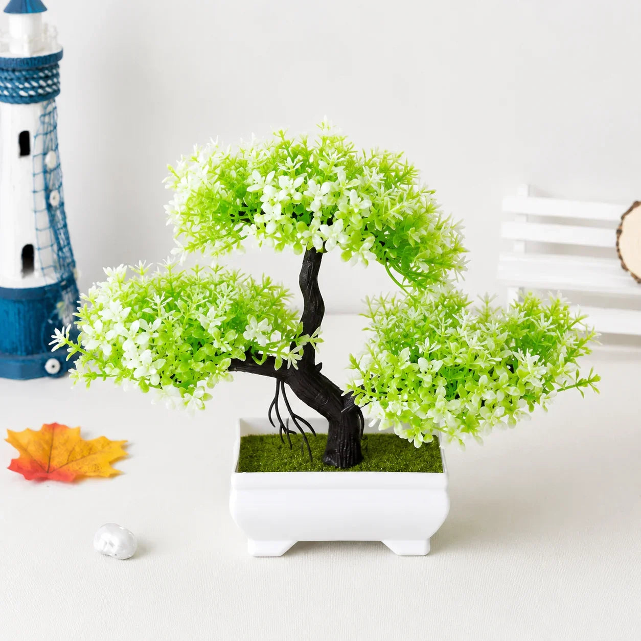 Artificial bonsai tree with green leaves in white ceramic pot for home decor
