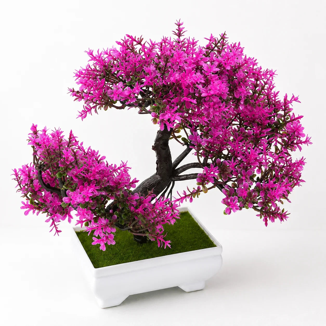 Pink artificial bonsai tree in white ceramic pot with green moss, ideal for home décor