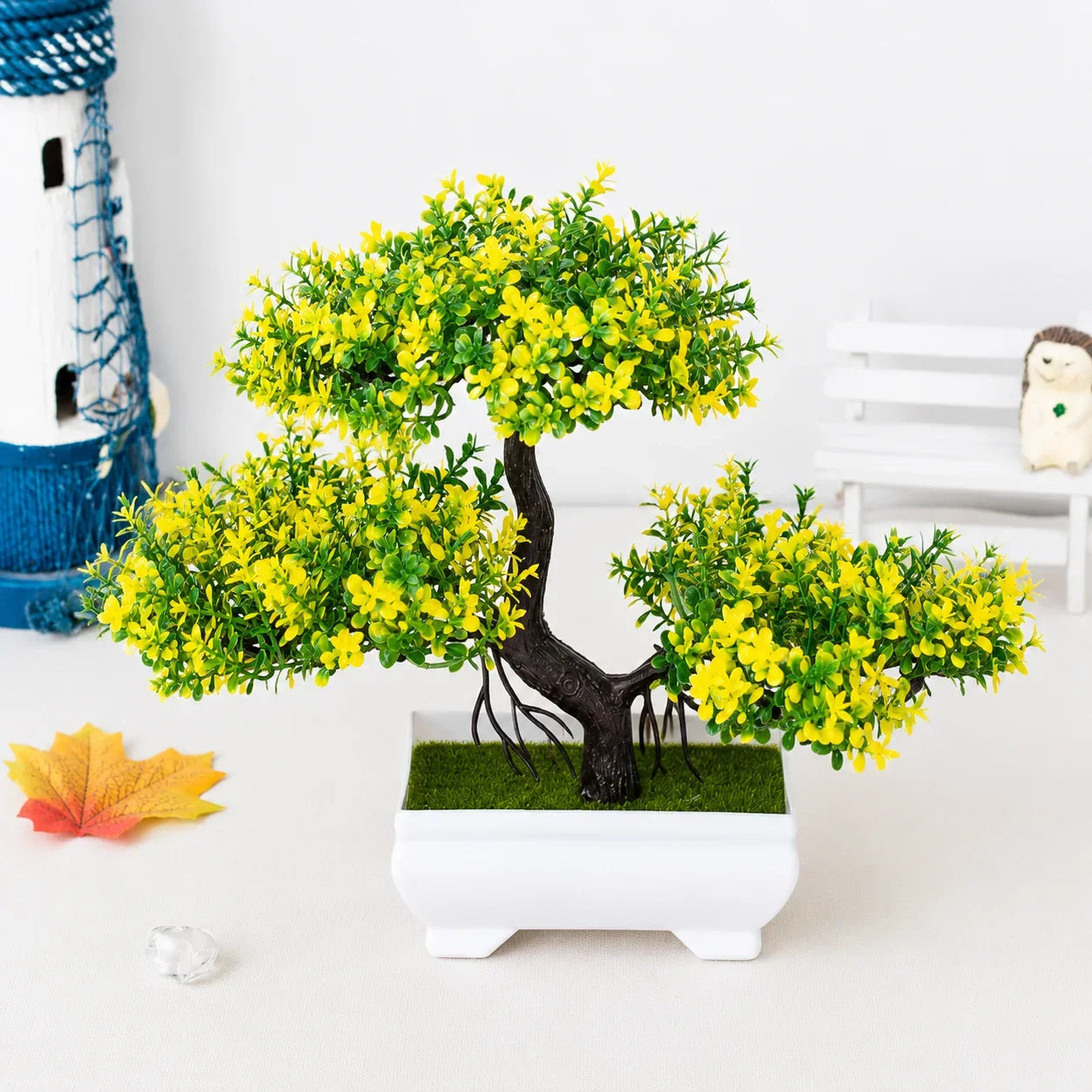 Artificial bonsai tree with yellow flowers in white ceramic pot for home decor