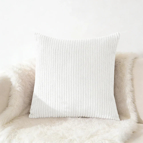 White corduroy square throw pillow for cozy home décor on fluffy surface