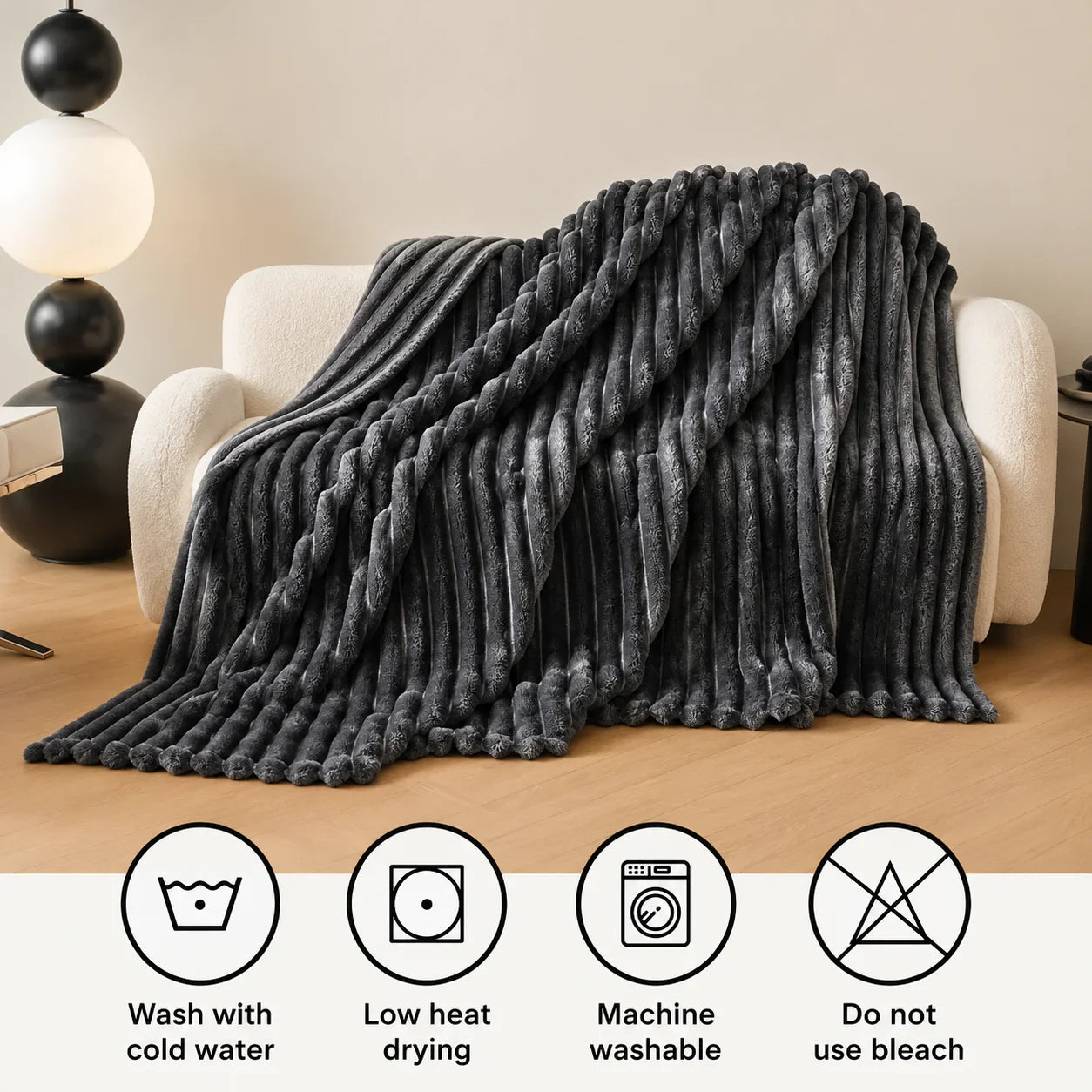 Gray plush ribbed throw blanket draped over cream armchair for cozy living room comfort