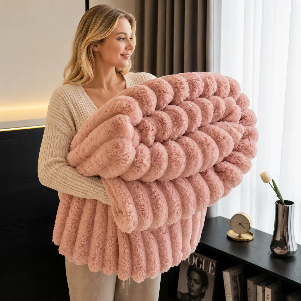 Soft pink chunky knit faux fur throw blanket for cozy bedroom or living room decor