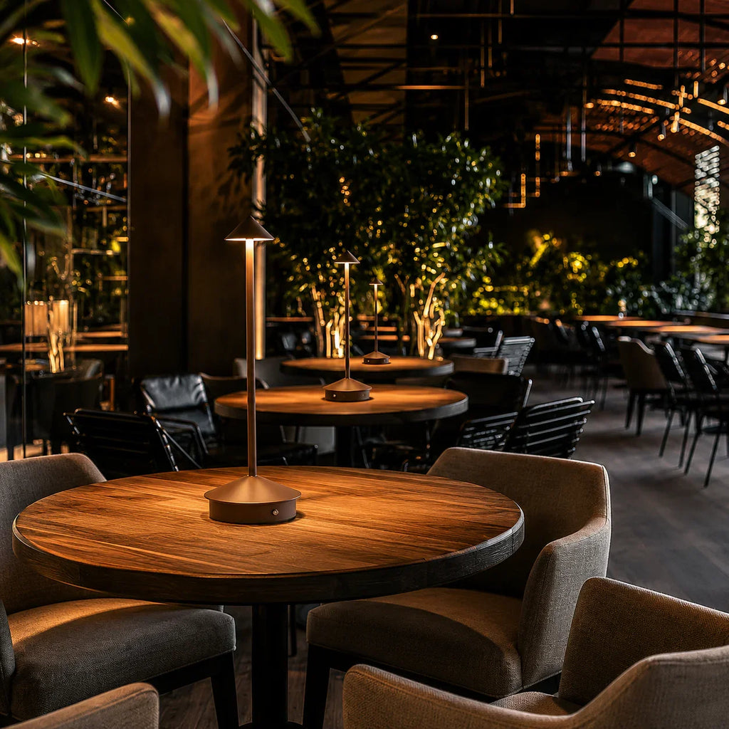 Modern brass table lamp on wooden dining table in cozy restaurant setting