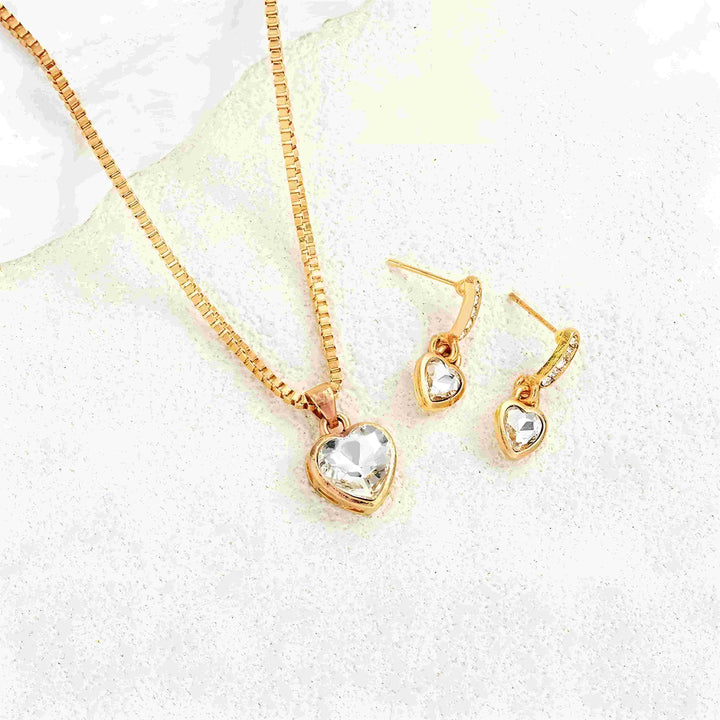 Gold heart pendant necklace and matching earrings with clear crystals, minimalist style