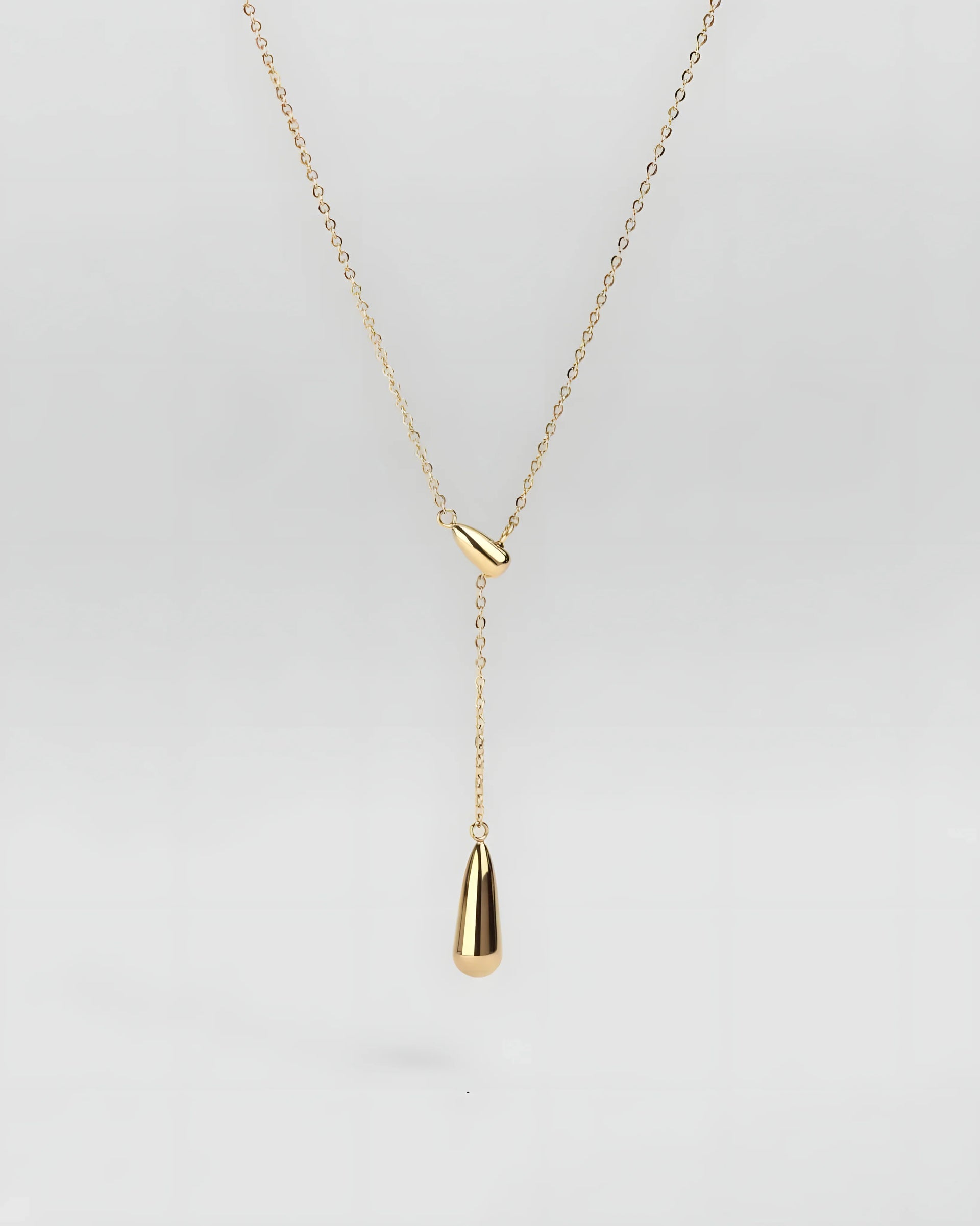 Gold teardrop lariat necklace with minimalist design and sleek chain