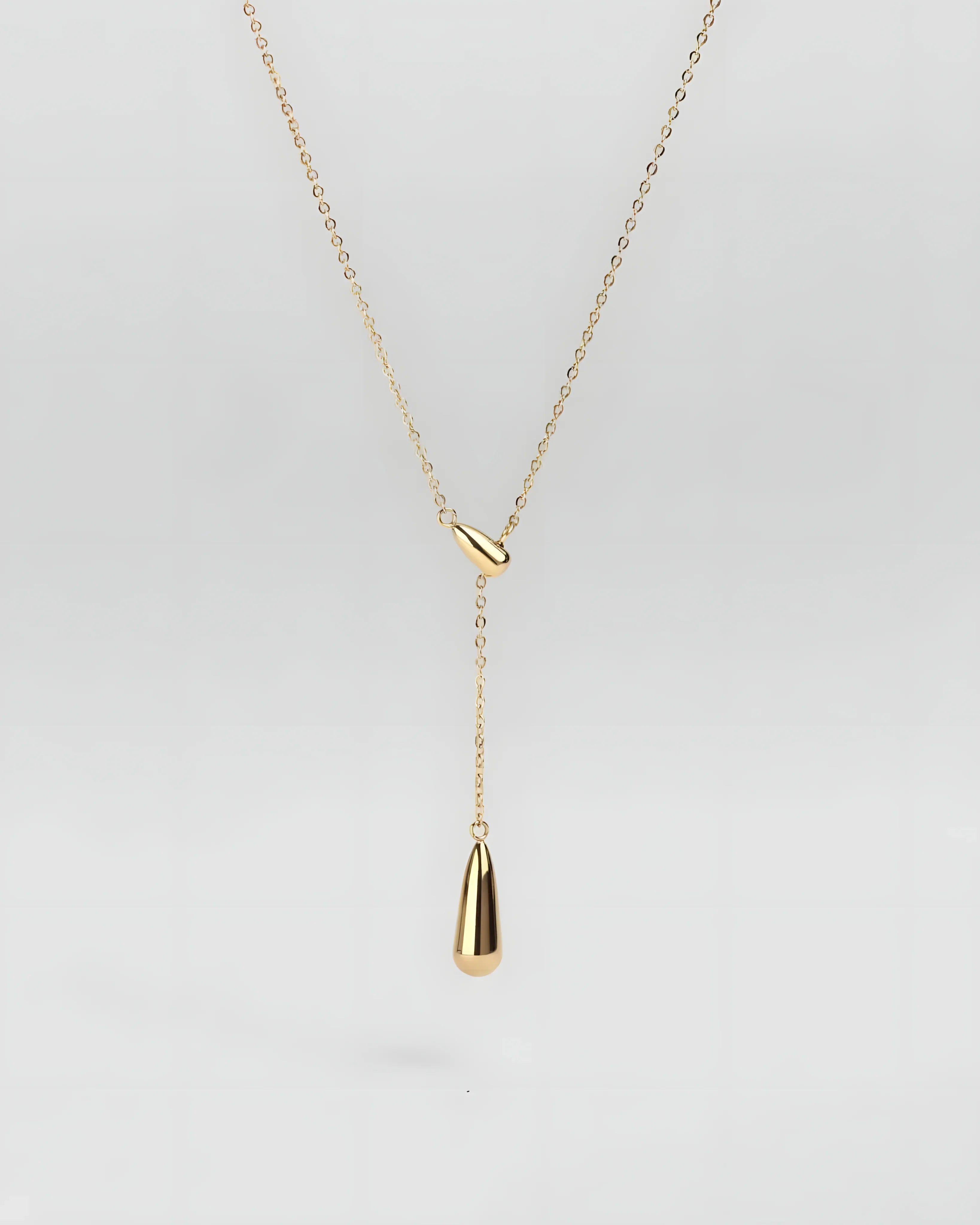 Gold teardrop lariat necklace with minimalist design and sleek chain