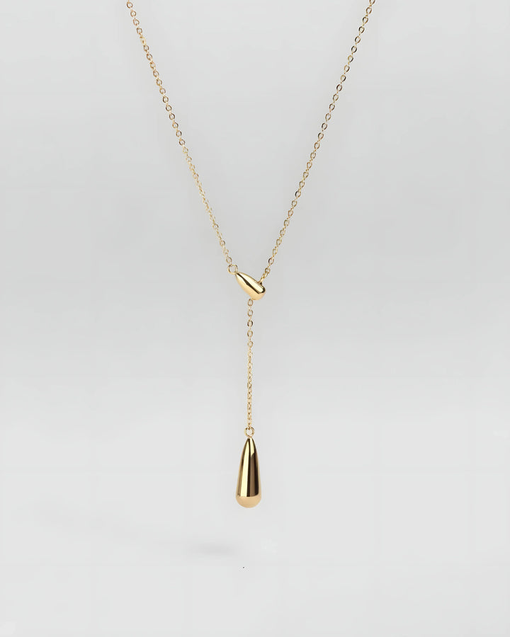 Gold teardrop lariat necklace with minimalist design and sleek chain