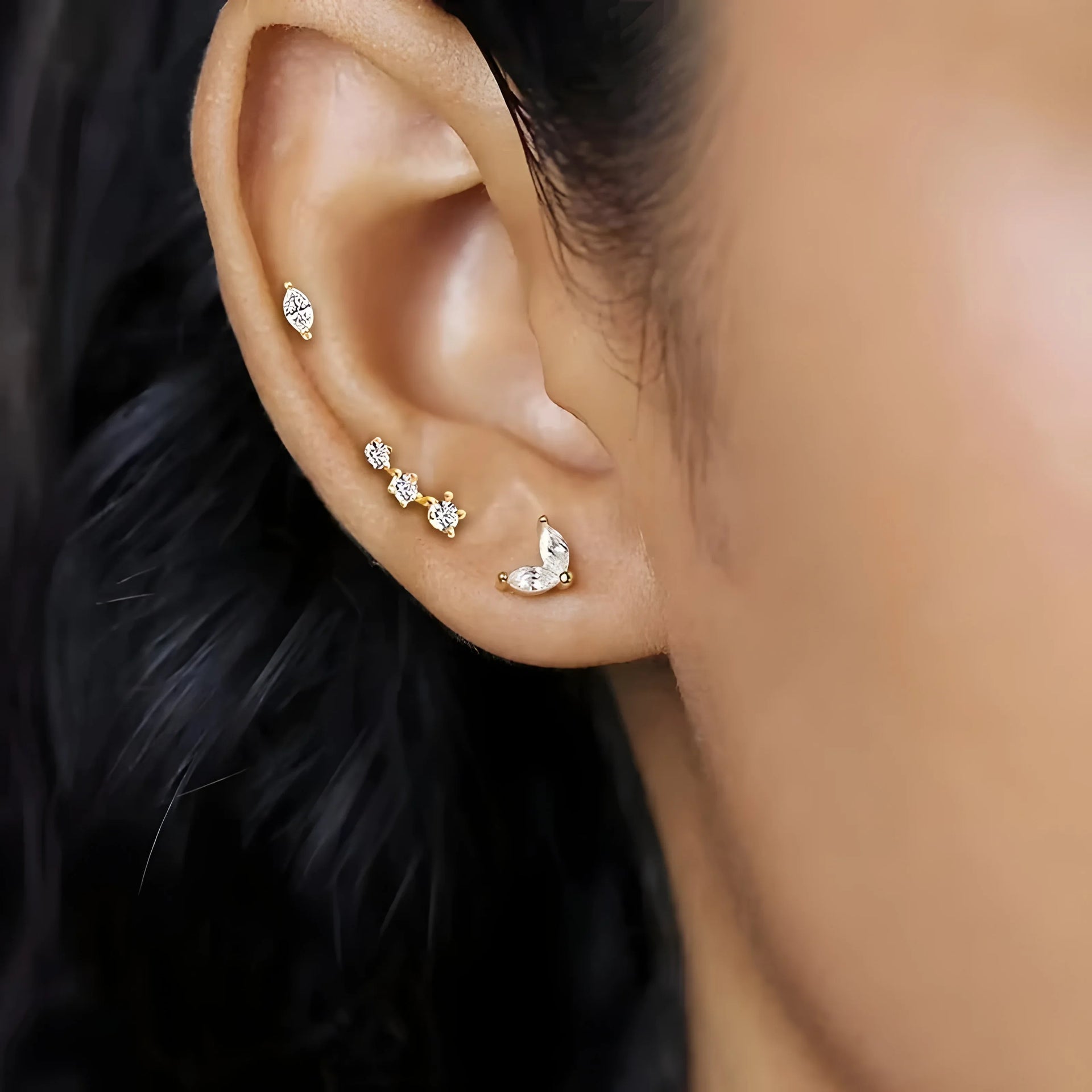 Essential Stud Set gold earrings with clear stones, minimal style, worn on ear, modern jewelry