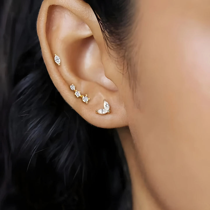 Essential Stud Set gold earrings with clear stones, minimal style, worn on ear, modern jewelry