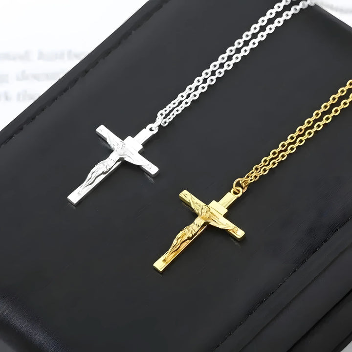 Silver and gold crucifix necklaces with detailed Jesus figure, minimal style on black background