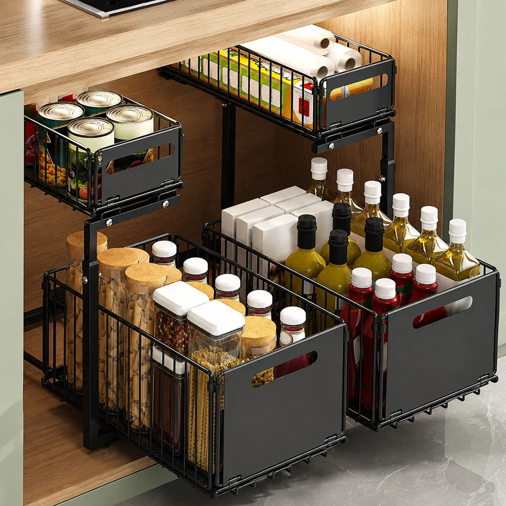 Black metal pull-out kitchen storage baskets organizing jars, bottles, and pantry items under a countertop