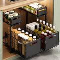 Black metal pull-out kitchen storage baskets organizing jars, bottles, and pantry items under a countertop