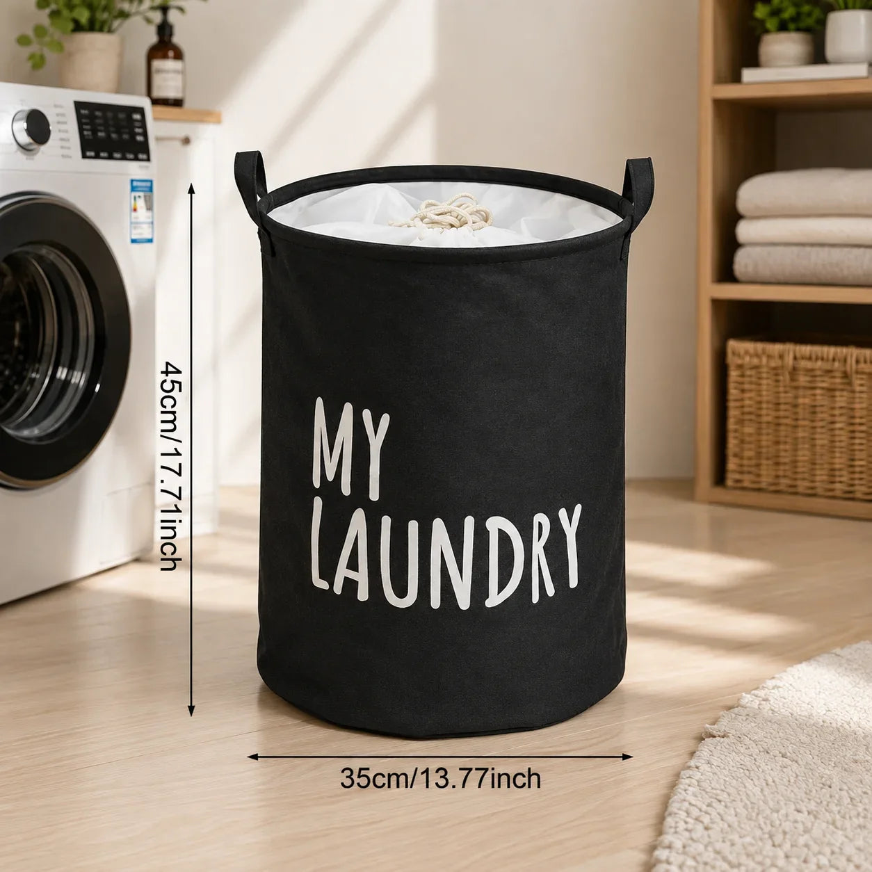Black fabric laundry hamper with white 'MY LAUNDRY' text, standing in a laundry room next to a washing machine.