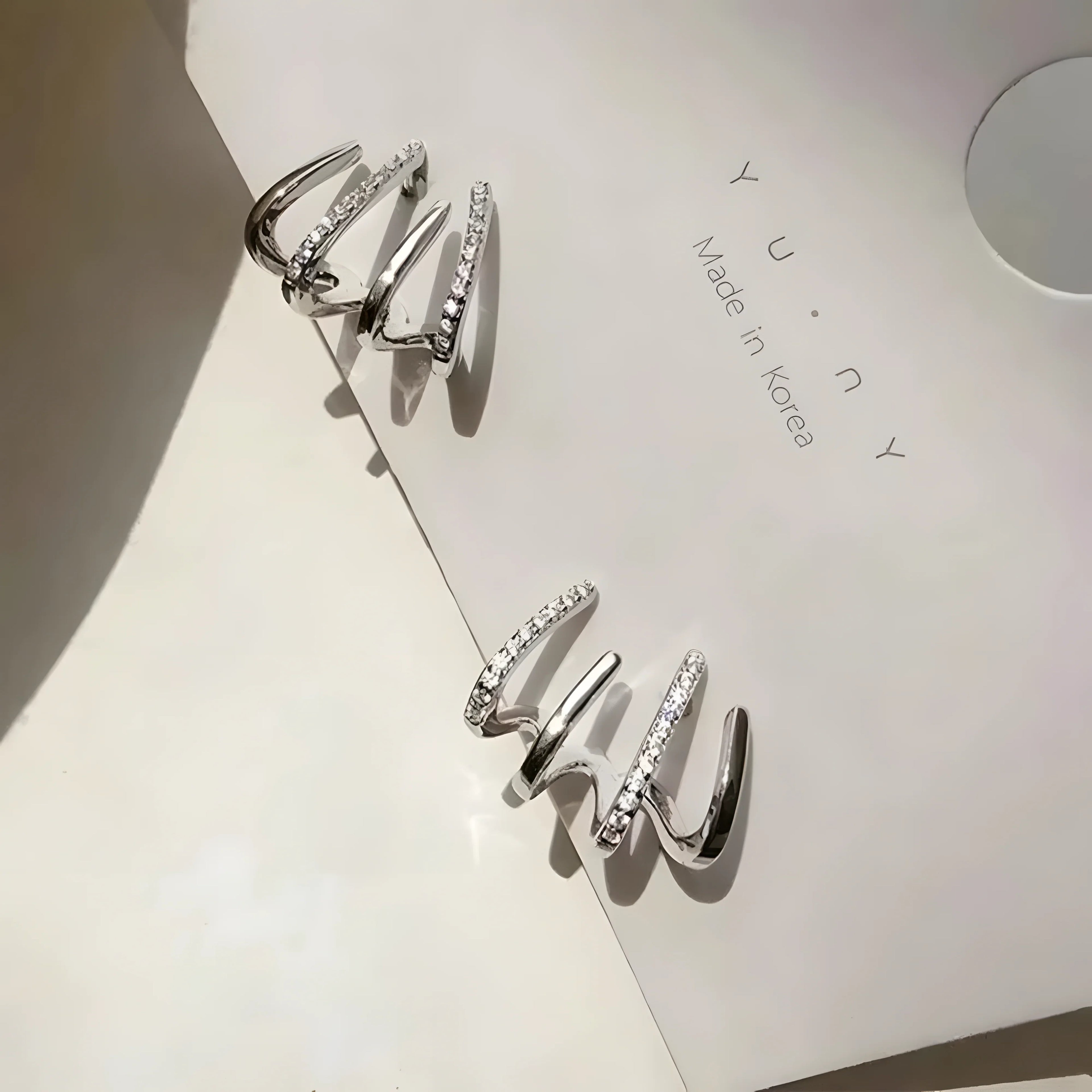 Four-Claw Stud Set silver spiral earrings with cubic zirconia, minimalist modern design