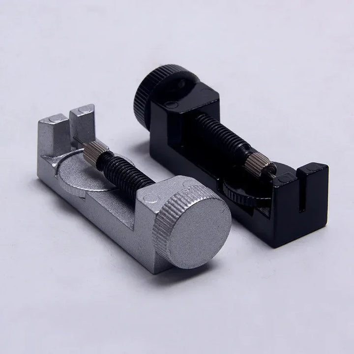 Metal band strap link pin remover tool in silver and black for jewelry adjustment