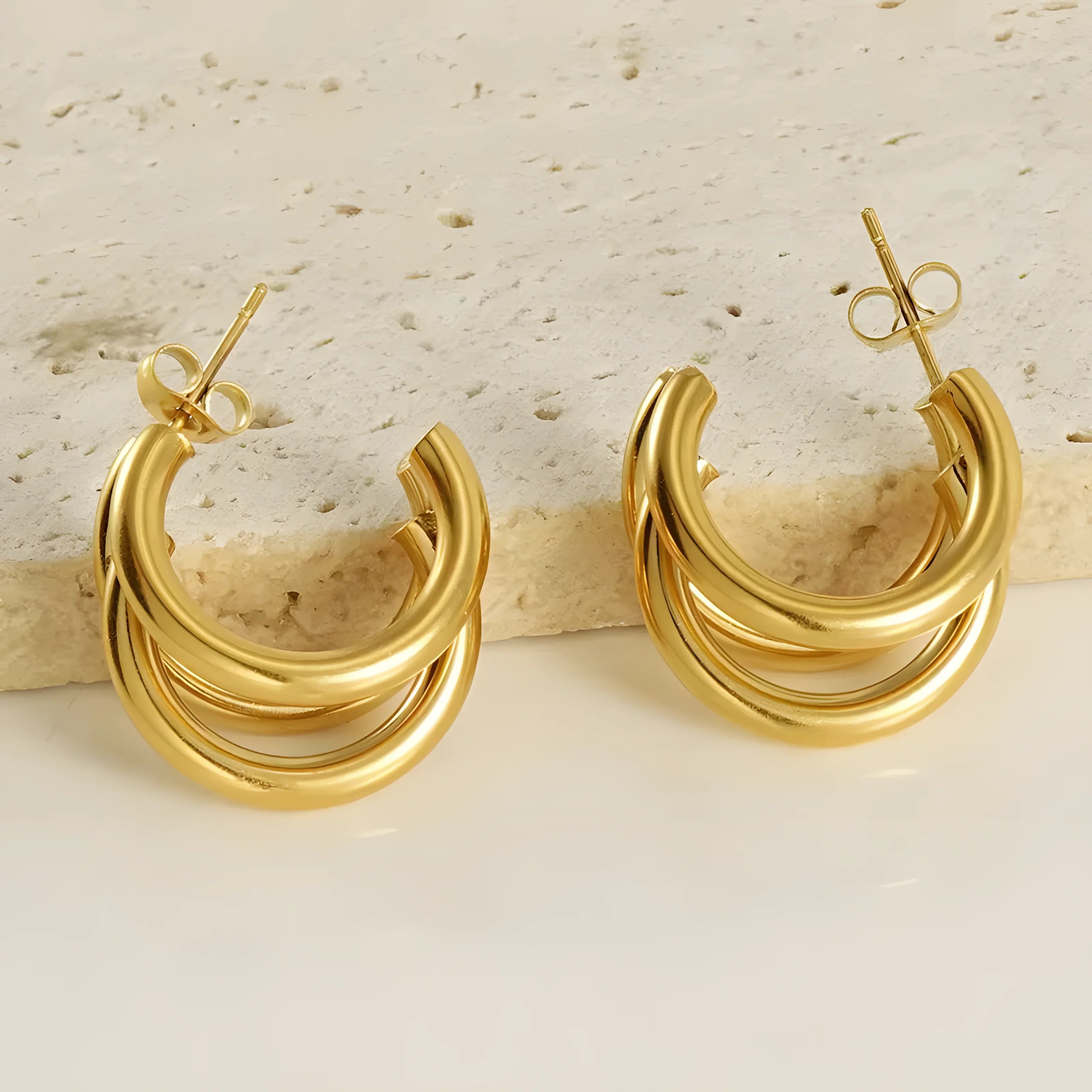 Gold triple hoop earrings, minimalist style, polished finish, modern jewelry design