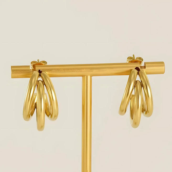 Gold hoop earrings with intertwined design, minimalist style, high-quality material