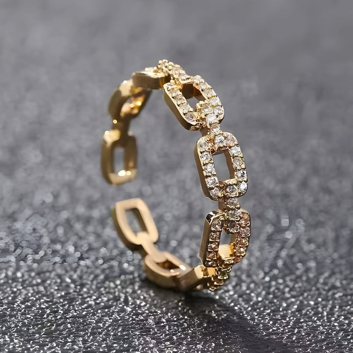 Gold link ring with rectangular chain design and clear stones, minimal modern jewelry style