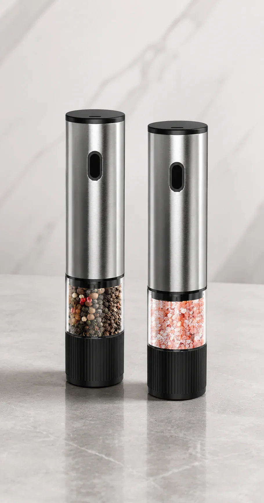 Stainless steel salt and pepper grinders with clear bases showing pink salt and mixed peppercorns