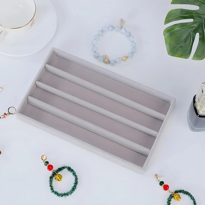 Light blue agate beaded bracelet with gold accents, minimalist style, on white surface with green leaf