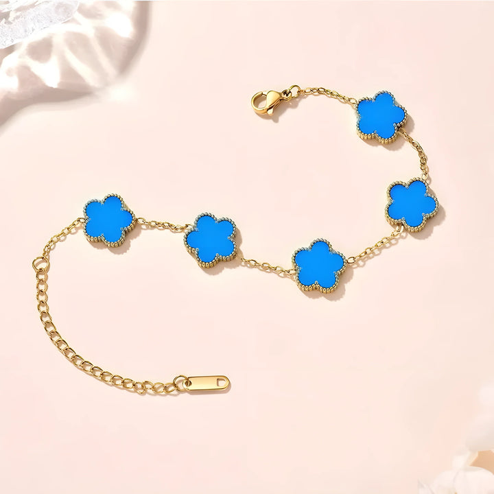 Gold chain bracelet with blue clover charms, minimalist style
