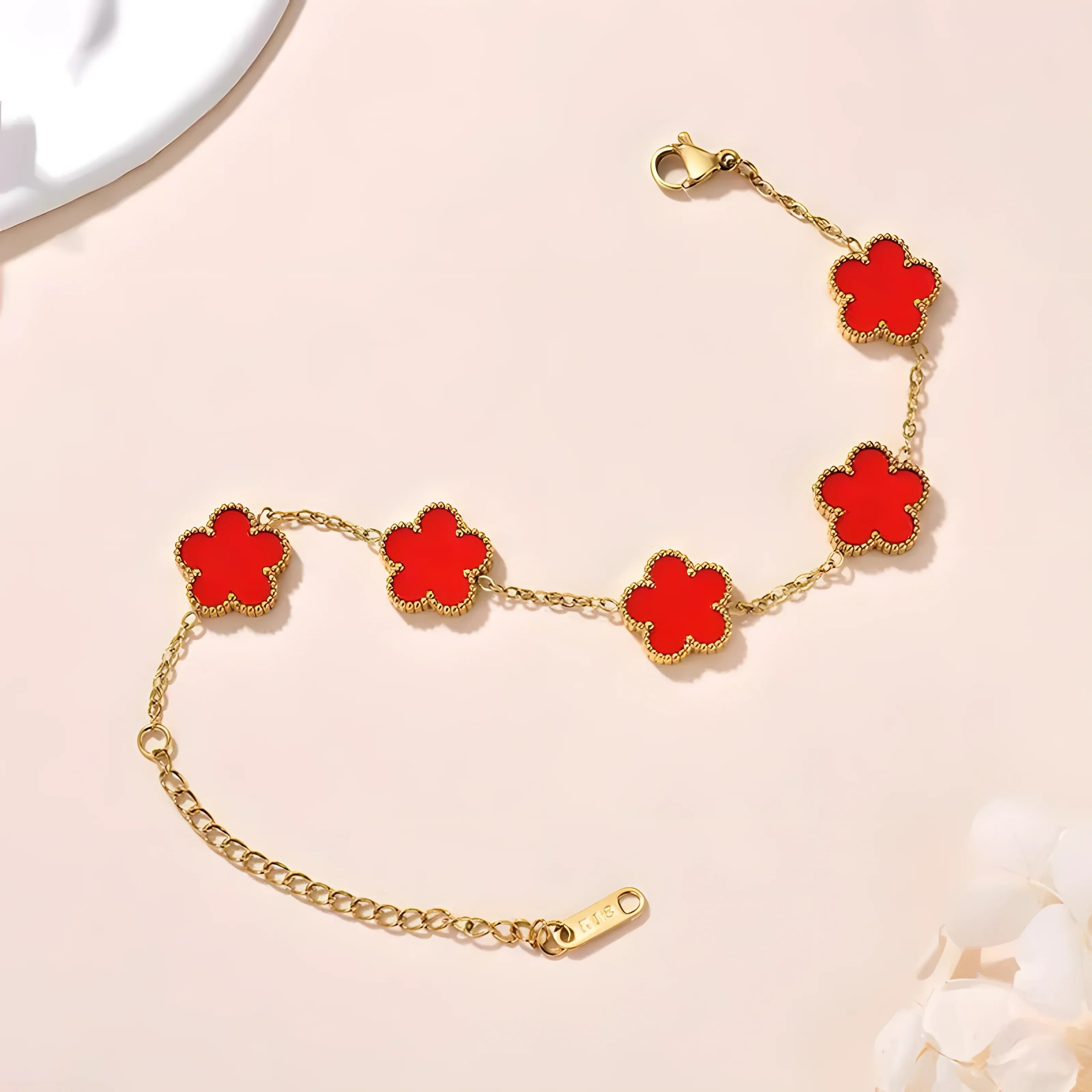 Gold bracelet with red clover charms, minimalist style, everyday wear