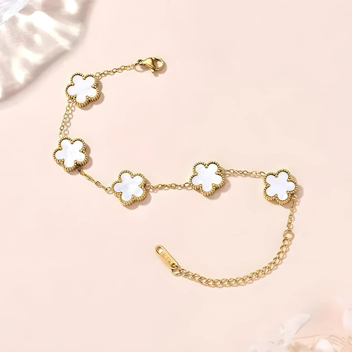 Gold bracelet with white clover charms, minimal design, everyday elegance
