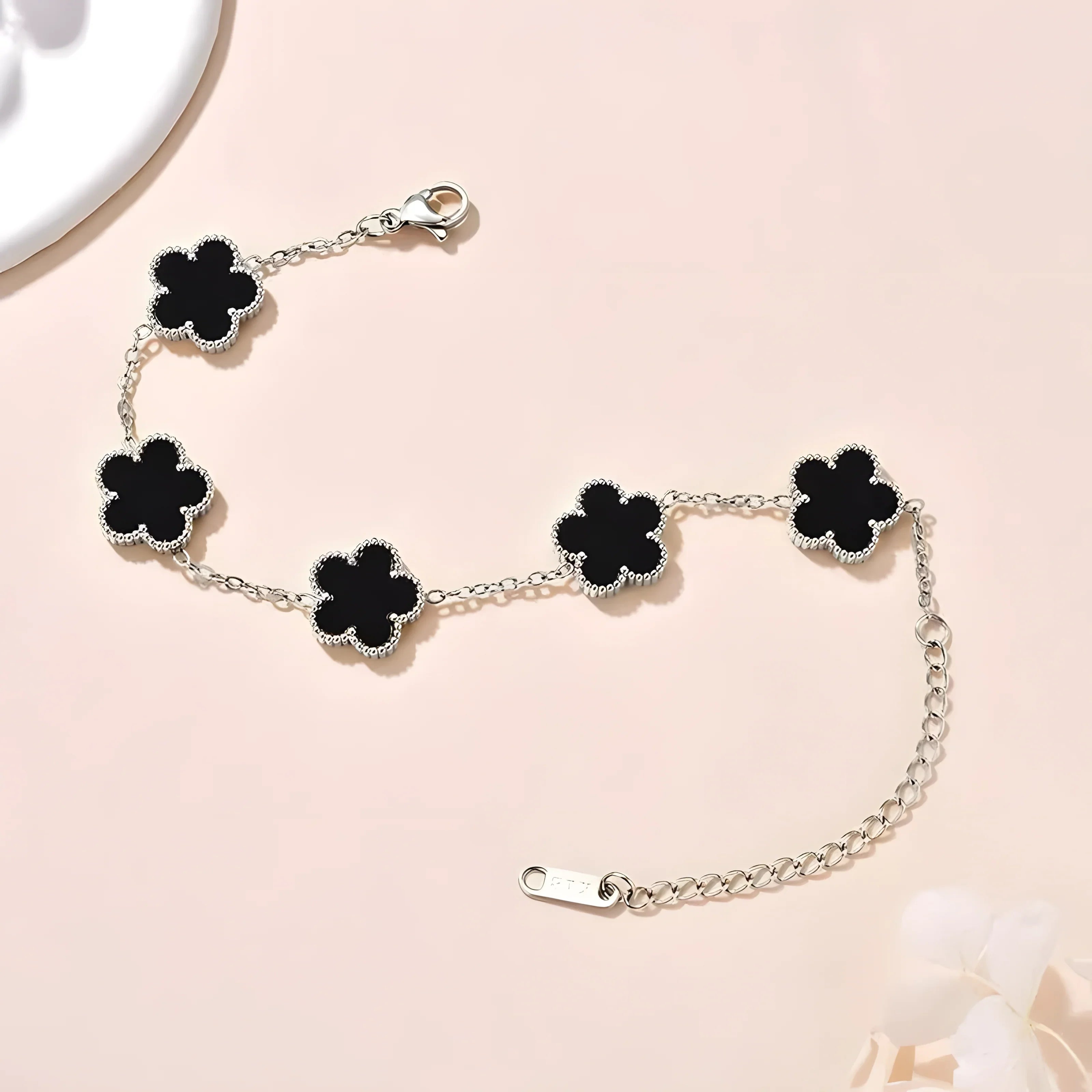 Silver chain bracelet with black clover charms, minimalist style