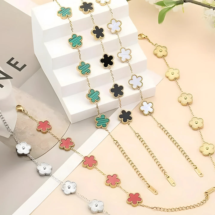 Gold and silver clover charm bracelets in green, black, white, pink, and gold tones, minimalist style