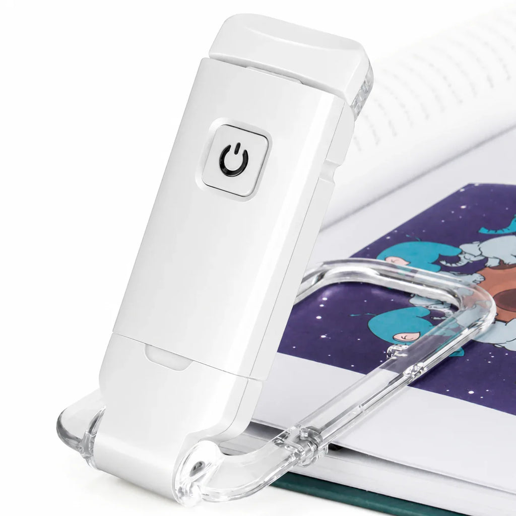 White LED book light with clear clip, illuminating pages for reading