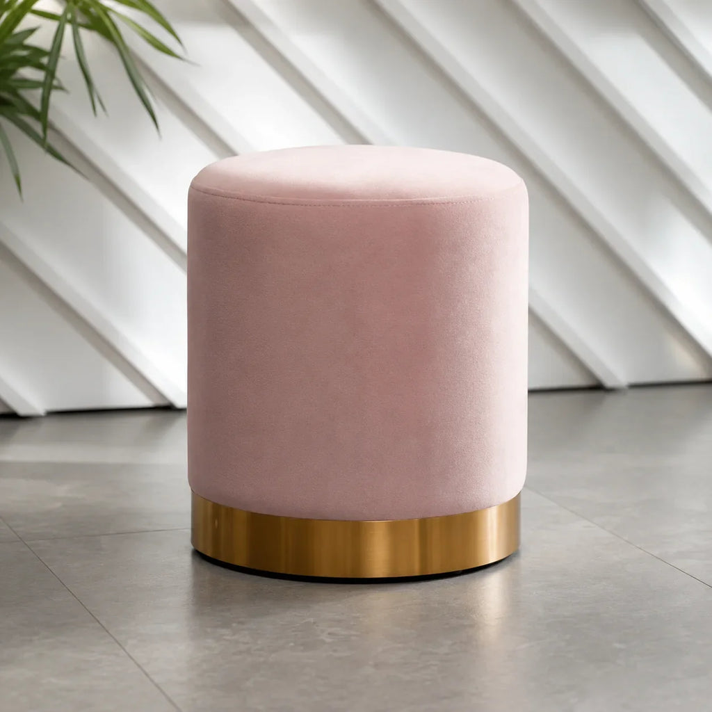 Pink velvet cylindrical ottoman with gold metal base for living room or bedroom seating