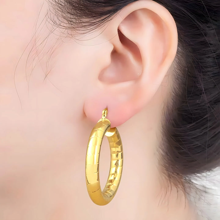 Minimal Hoop Earrings gold-toned metal, chunky style, worn on ear, modern jewelry