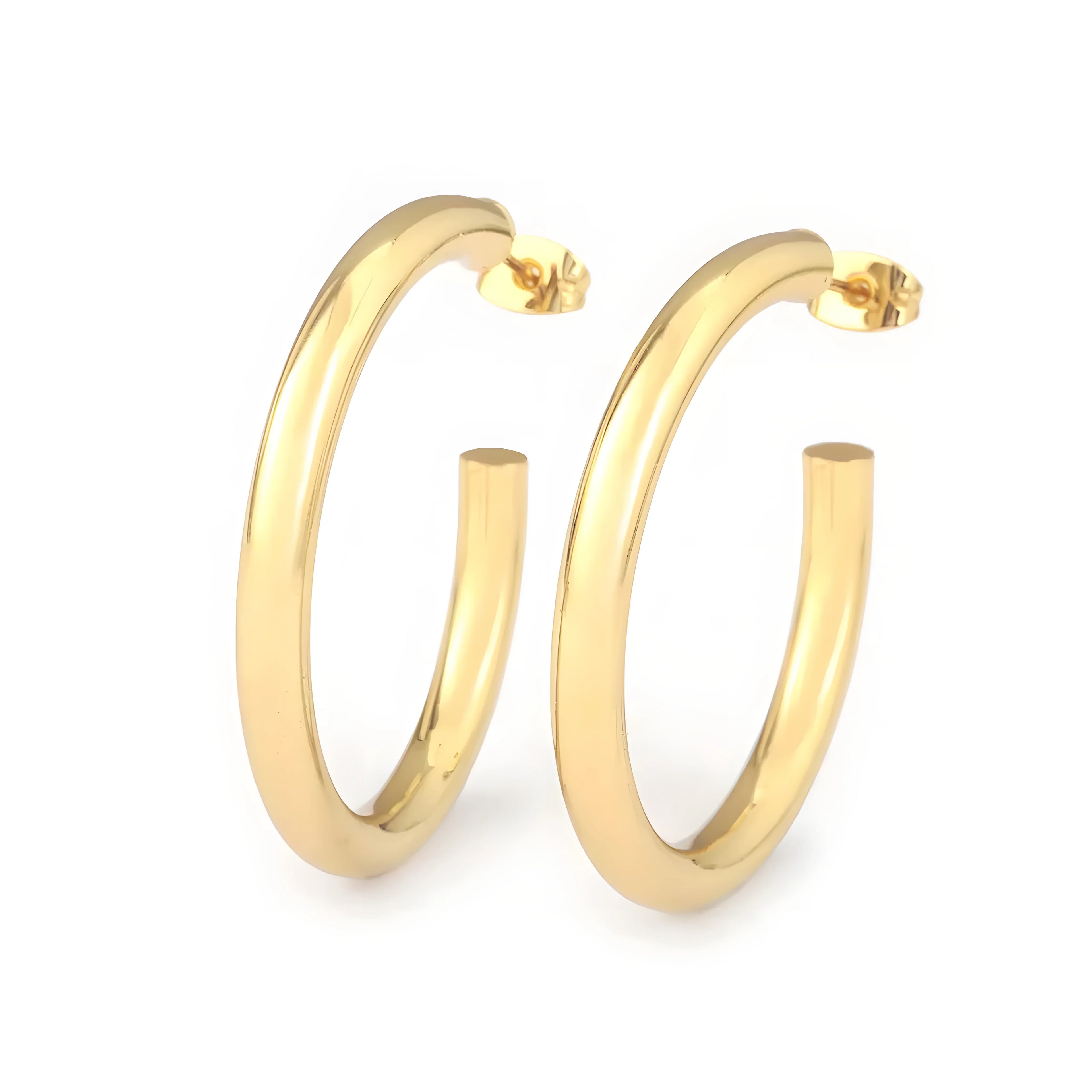Minimal hoop earrings in gold metal, classic round style, polished finish, modern jewelry
