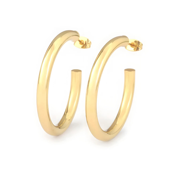 Minimal hoop earrings in gold metal, classic round style, polished finish, modern jewelry