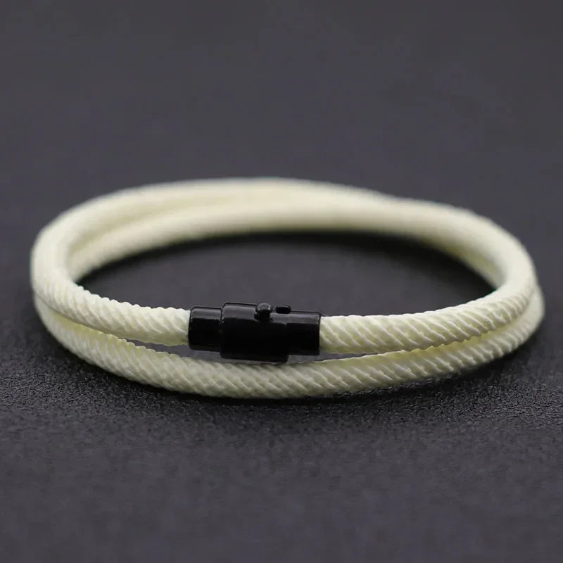 Minimalist rope bracelet, cream color, nylon material, with black metal clasp, modern style.