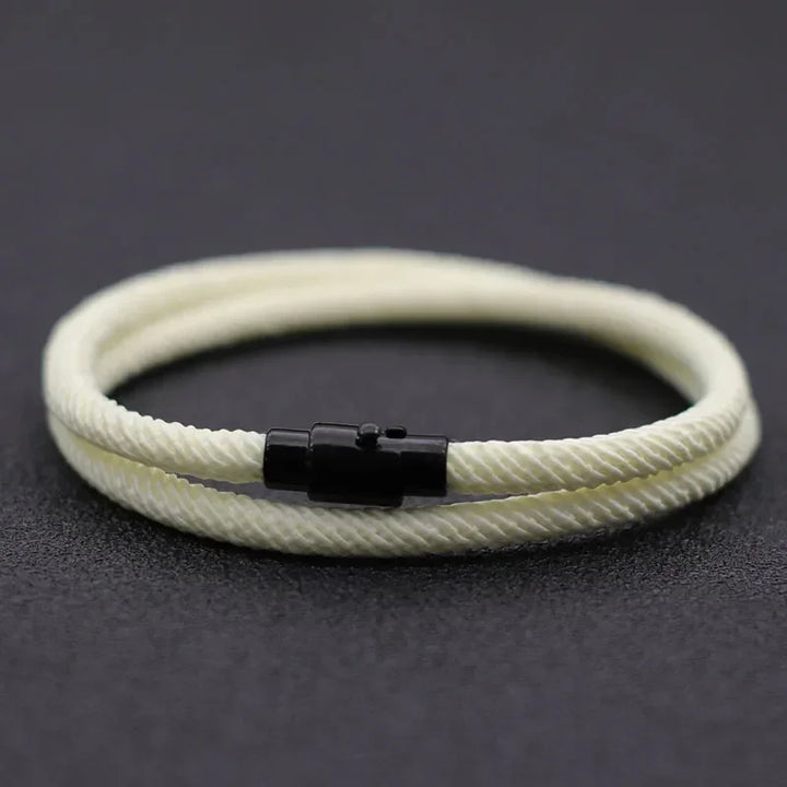 Minimalist rope bracelet, cream color, nylon material, with black metal clasp, modern style.
