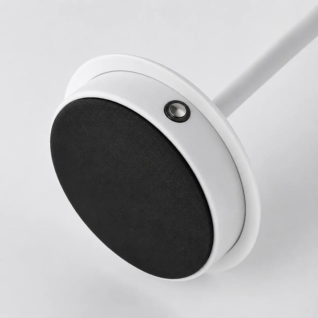 White circular wall-mounted hook with black felt pad for organizing kitchen or bathroom items