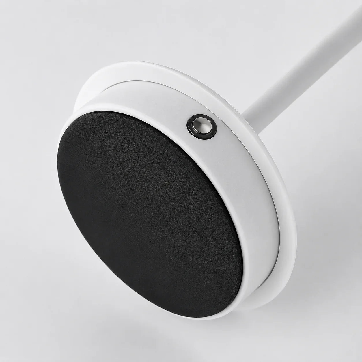 White circular wall-mounted hook with black felt pad for organizing kitchen or bathroom items
