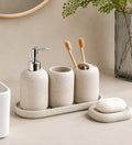 Beige ceramic bathroom set with soap dispenser, toothbrush holders, and soap dish for modern organization