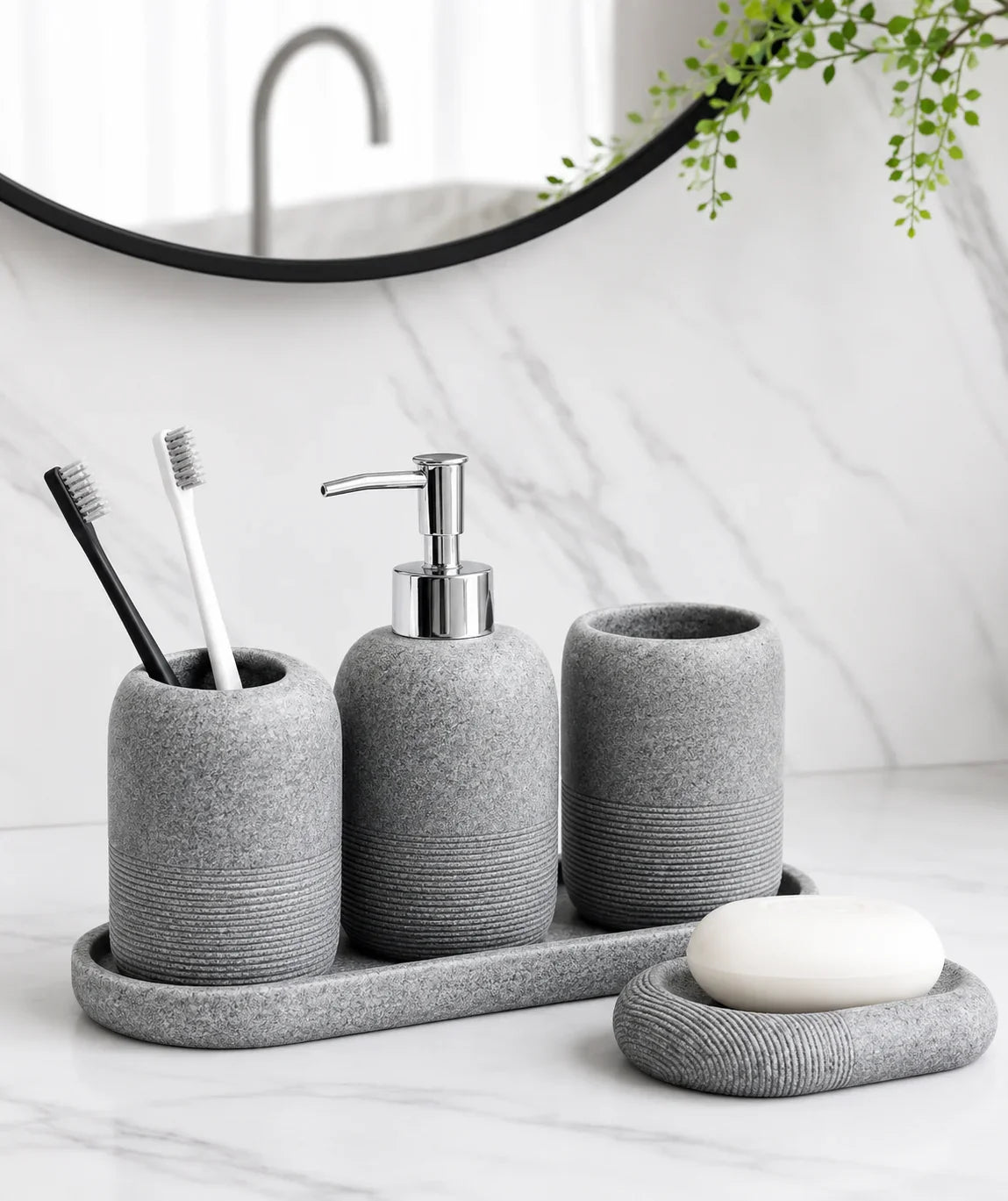 Gray stone-textured bathroom set with toothbrush holder, soap dispenser, tumbler, and soap dish on marble countertop