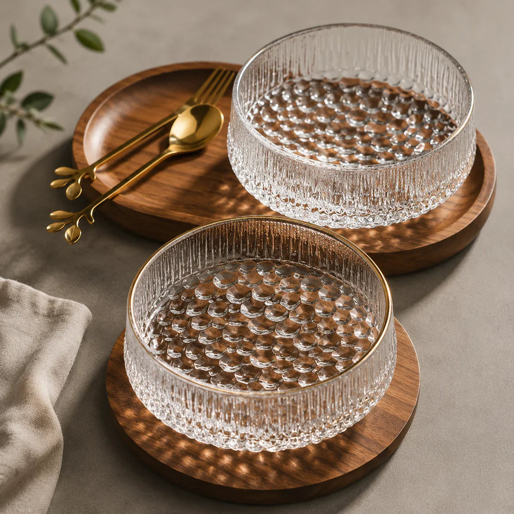 Clear textured glass bowls with gold rims on wooden trays, ideal for kitchen or dining use