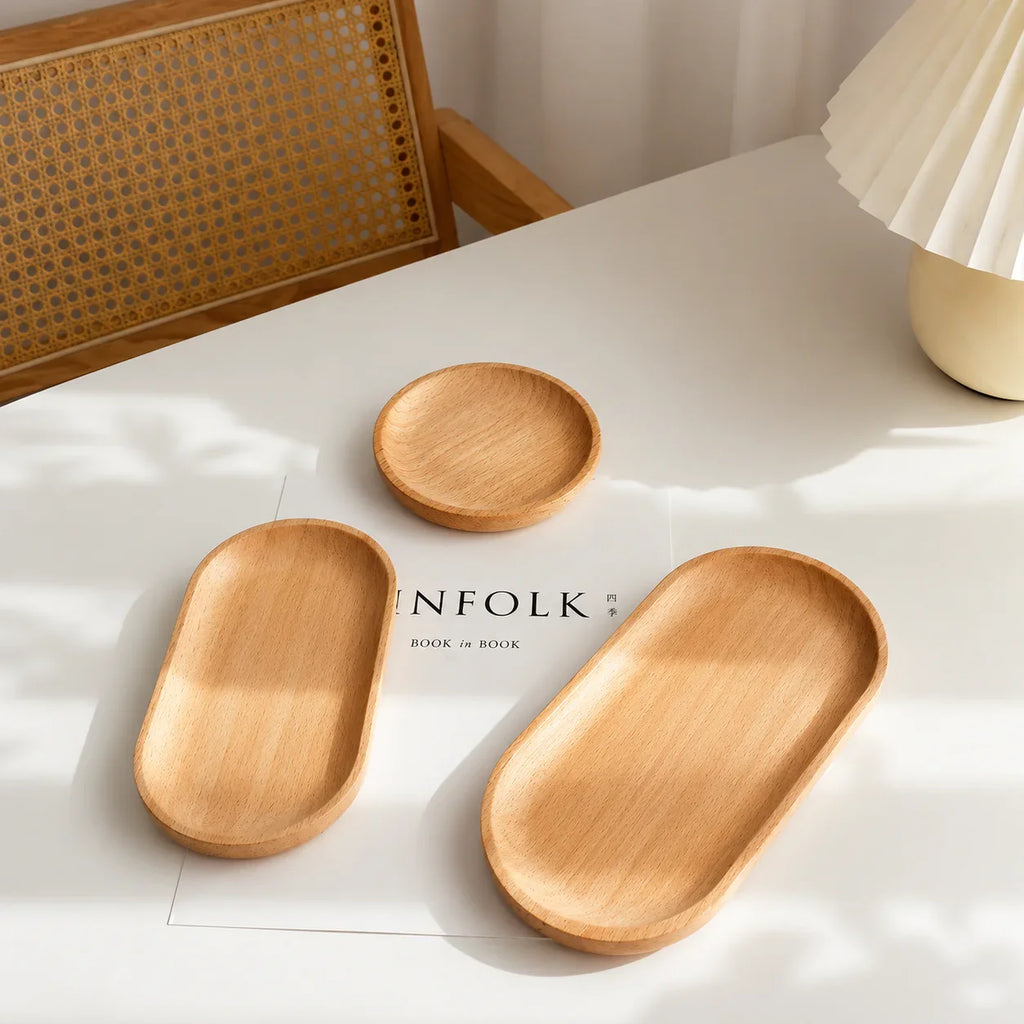 Natural wood oval and round trays for kitchen or bathroom organization, minimalist home decor