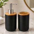 Black ceramic soap dispenser and toothbrush holder with bamboo lids for modern bathroom organization