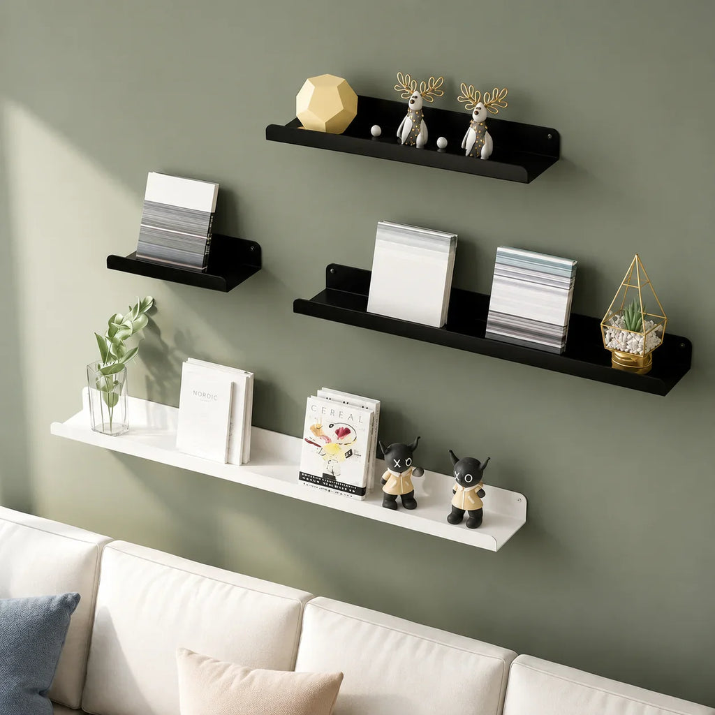 Black and white floating shelves displaying books, decor, and plants in a modern living room