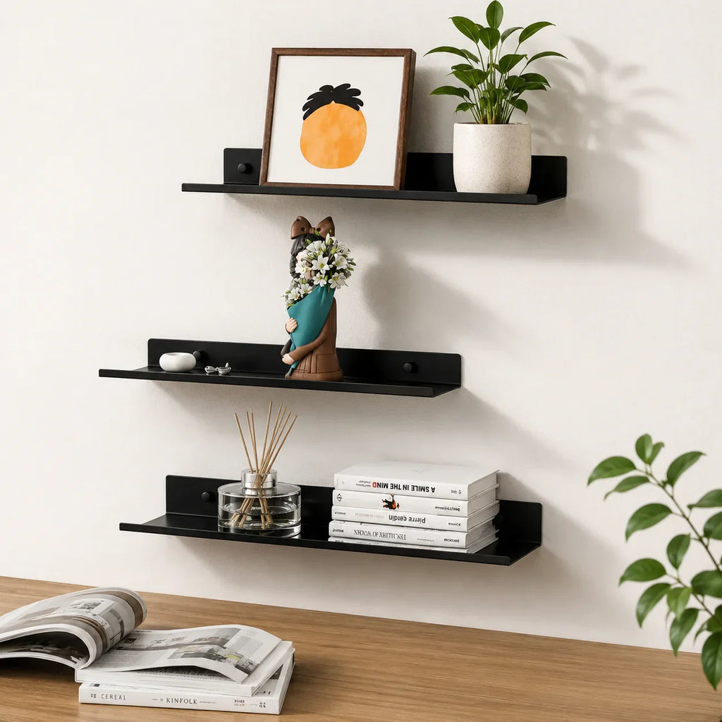 Black floating shelves displaying decor, books, and plants for modern home organization