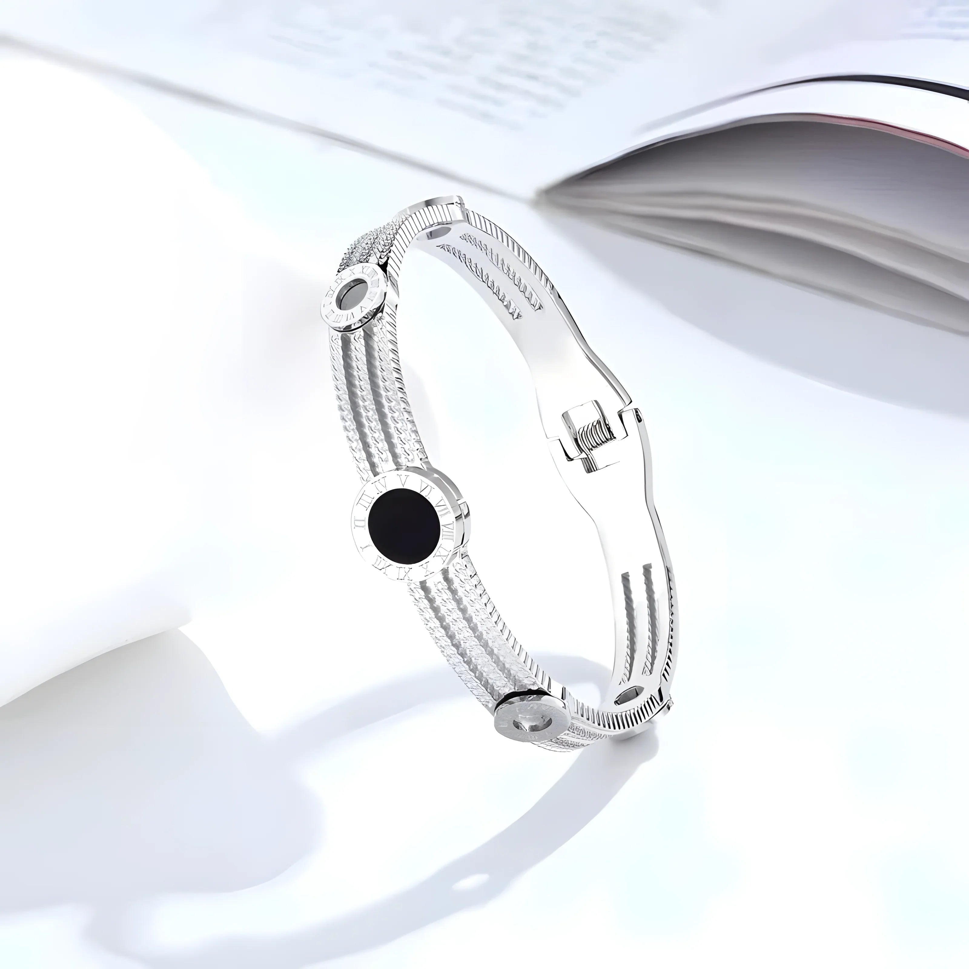 Silver bangle bracelet with black onyx and Roman numeral accents, minimalist design