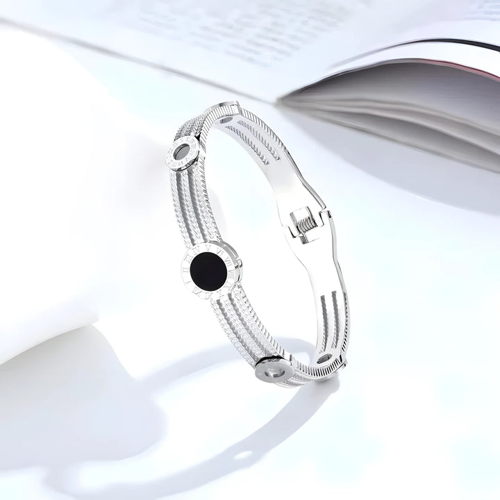 Silver bangle bracelet with black onyx and Roman numeral accents, minimalist design